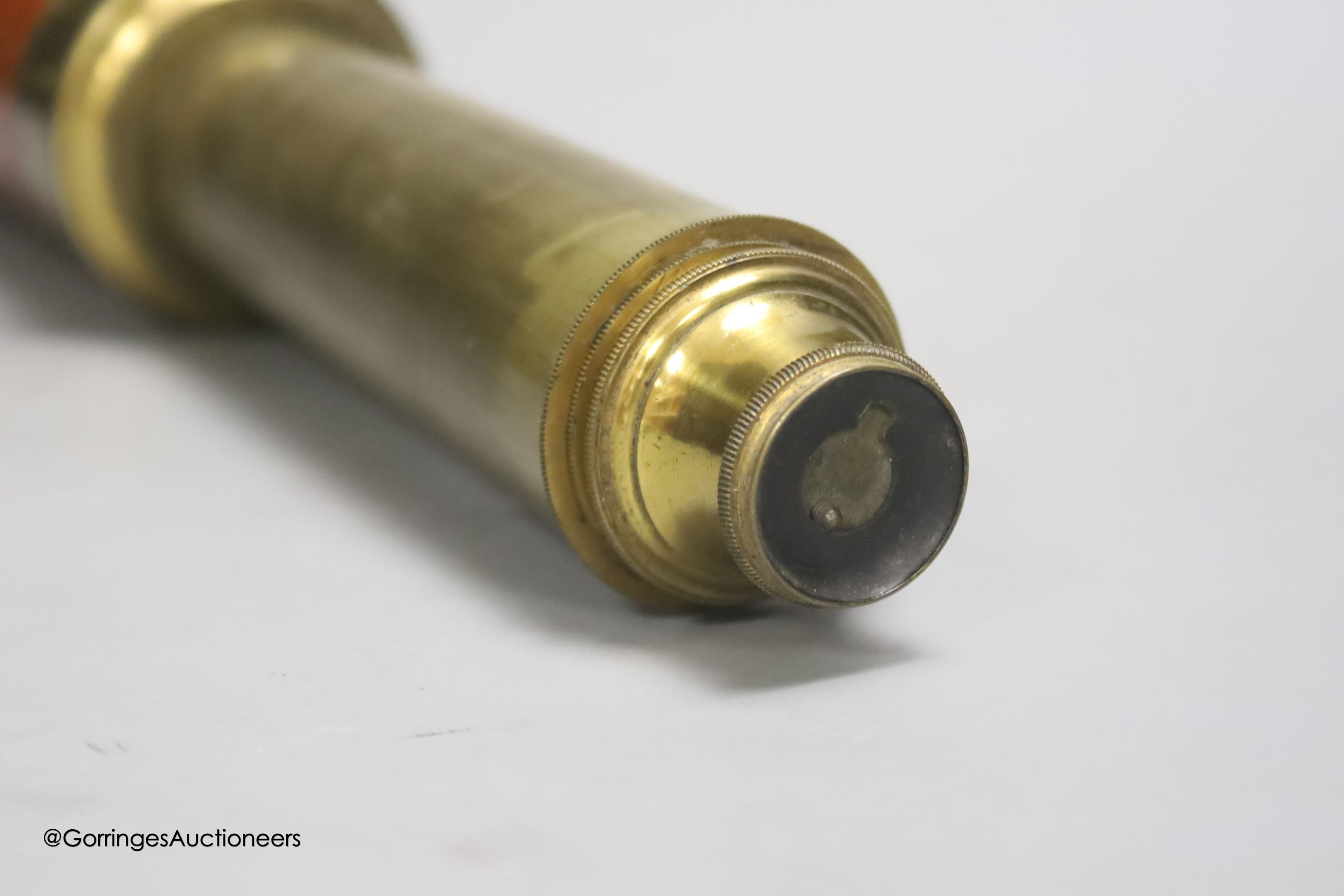 A Dolland of London three drawer brass and leather telescope, fully extended 83cm